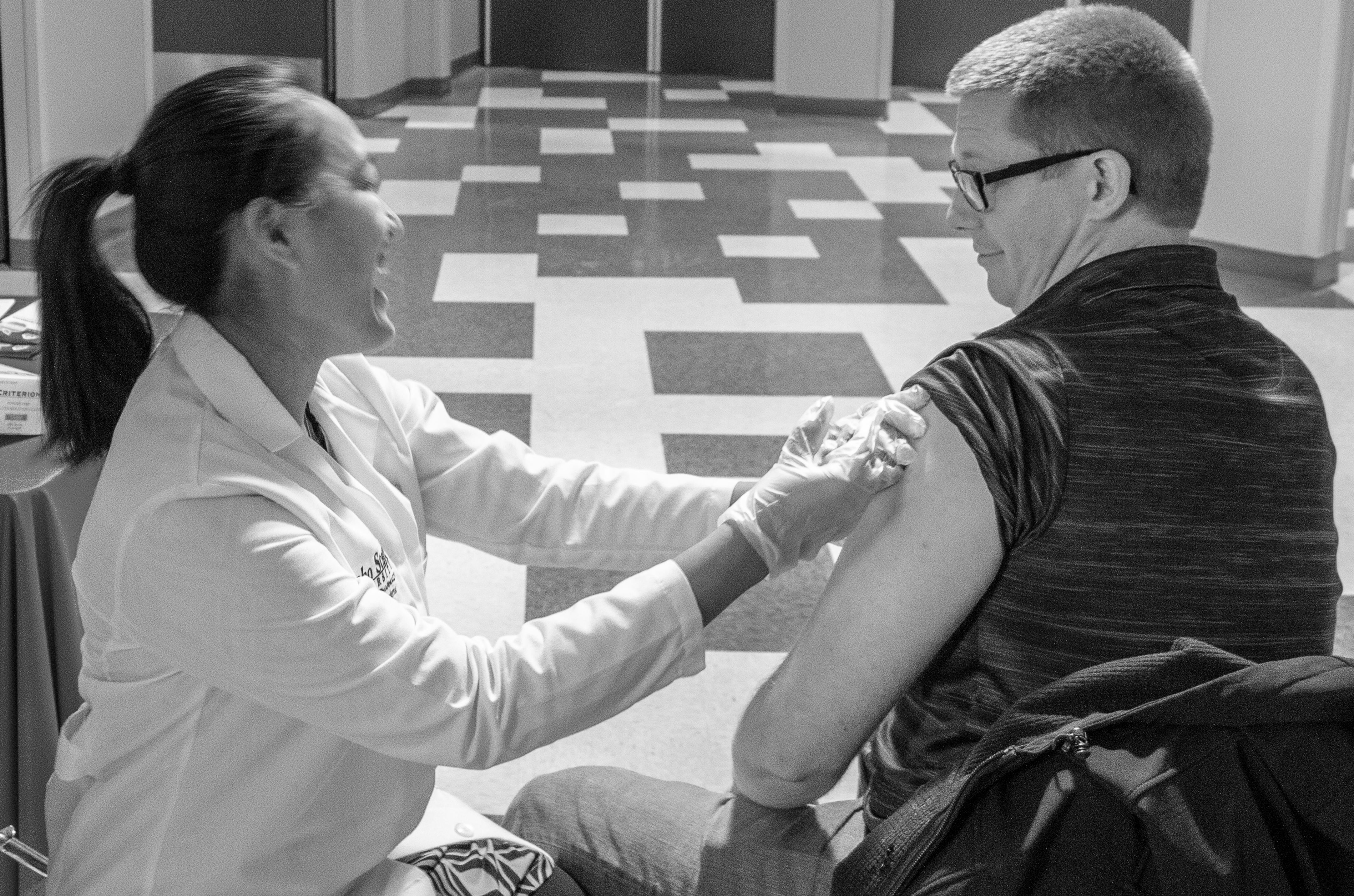 Student pharmacist administers flu shot to another student at ISU-Meridian