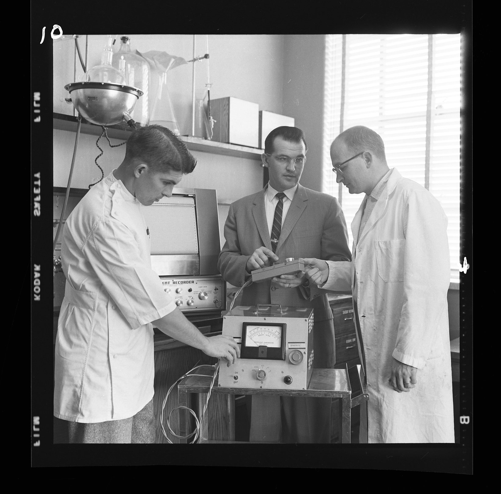 Historical photo of pharmacy dean and students in lab