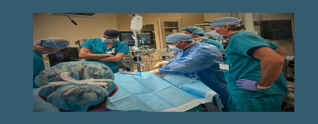 medical professionals surround a patient having surgery