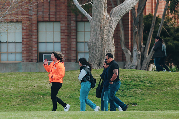 A student guides a group on a tour of the ISU campus