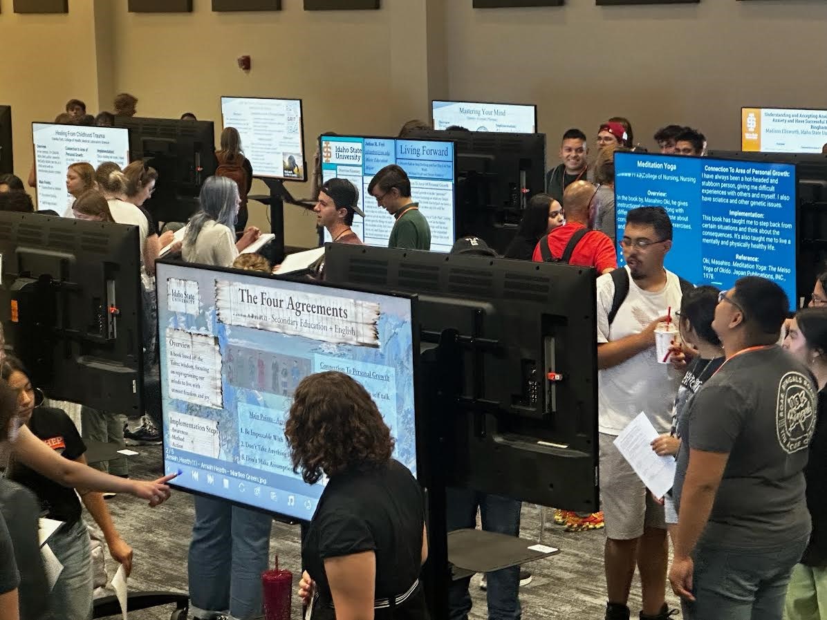 Student presenting to peers at the poster session