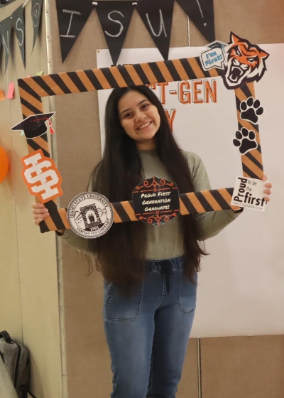 One student holding first gen photo prop