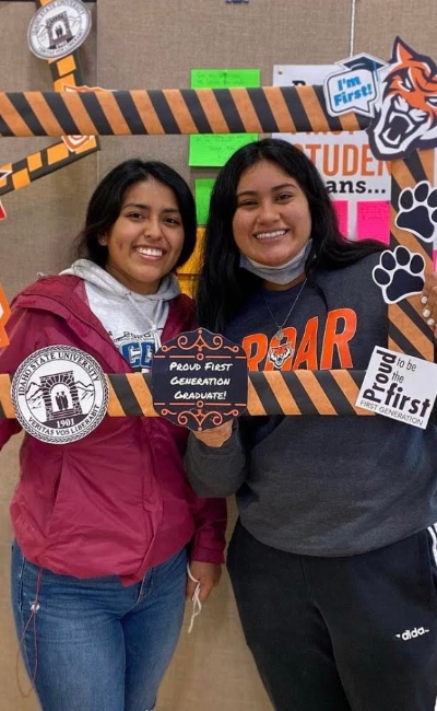 Two students holding first gen photo prop