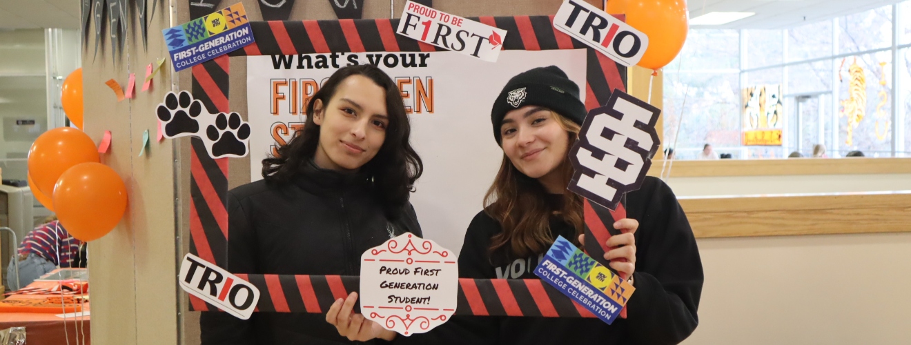 First Gen Club students, holding a sign that says proud to be first, trio, and first generation college student.