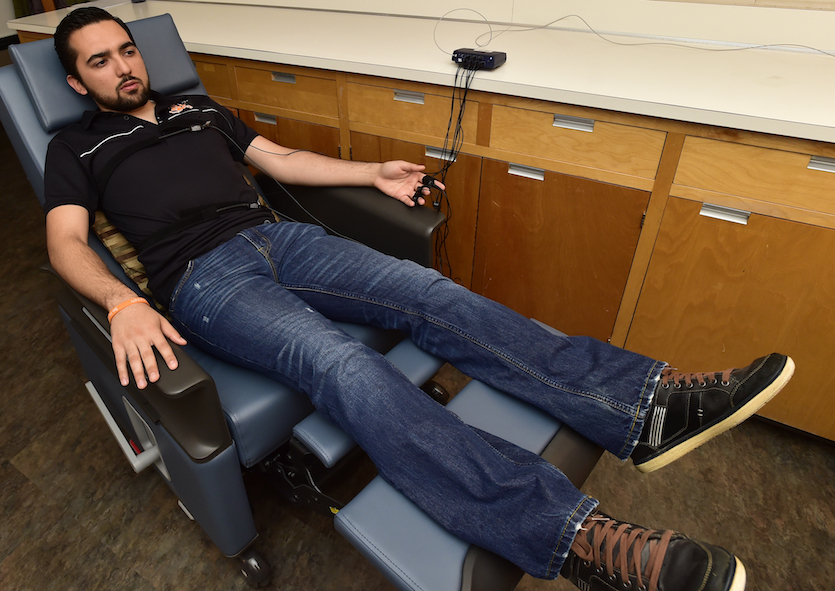 Photo of student in reclining chair receiving biofeedback treatment. 