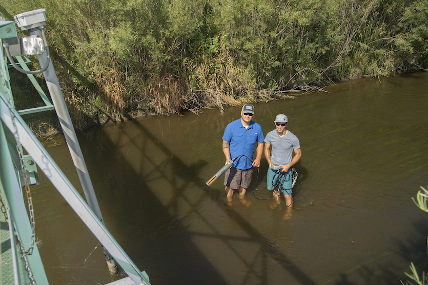 Photo from up above of two student researchers in Marsh Creek.