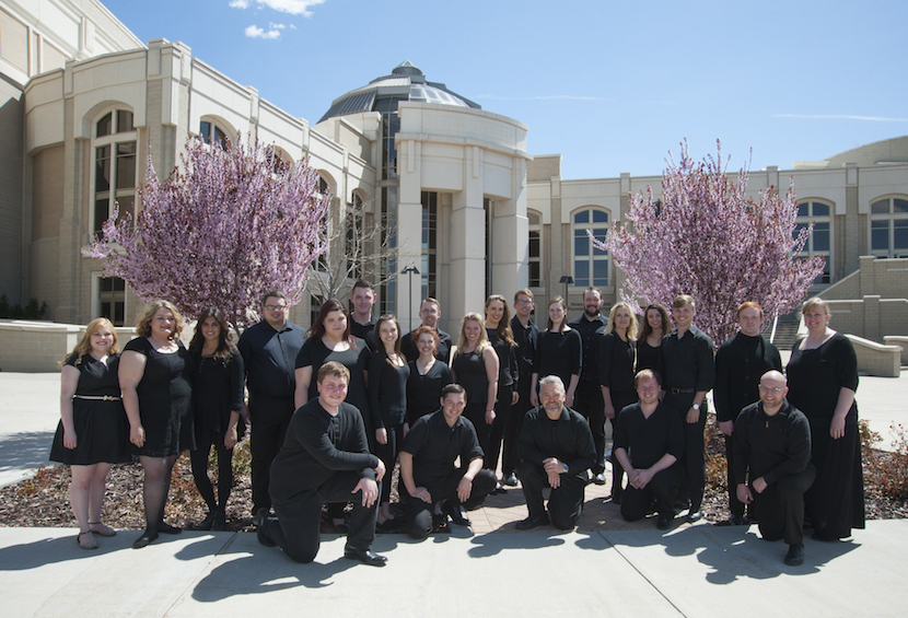 A group photo of the ISU Chamber Choir in front of the L.E. and Thelma E. Stephens Performing Arts Center