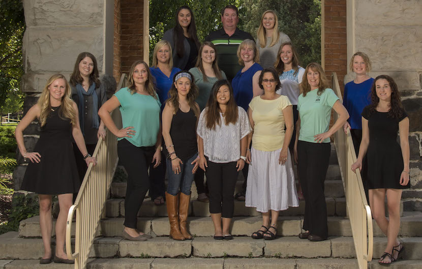 Speech pathology student group photo. Students are standing on some steps.
