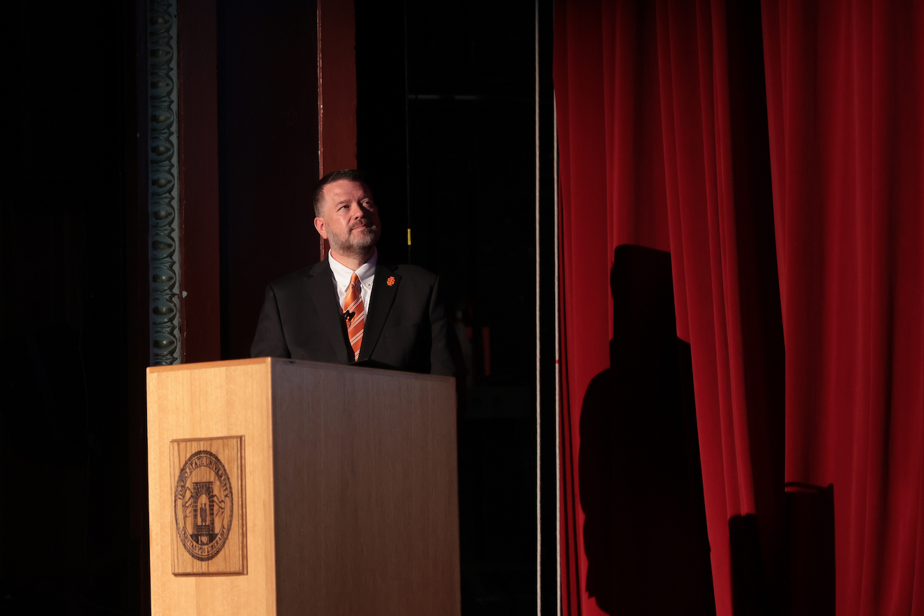 President Kevin Satterlee stands behind a podium