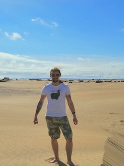 Wesley Peterson stands on a beach