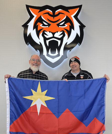 Two men holding a flag