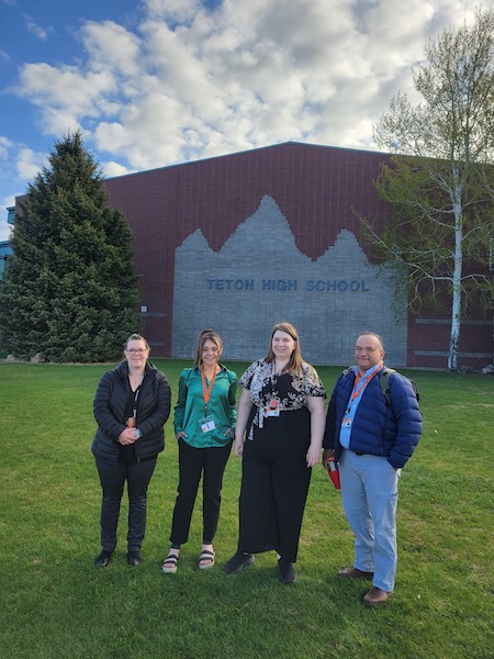 Four women stand in front of Teton High School