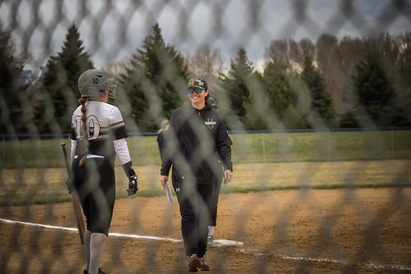 Kaitlyn Rizo who plays softball for Idaho State is seen through a fence.