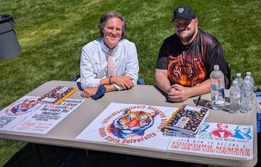 Two members of the Interdisciplinary Research Group at a table on the Quad.