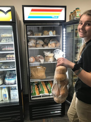 Student workers and volunteers help ensure the shelves are stocked at Benny’s Pantry