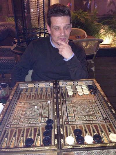 Photo of Zack Heern at backgammon table. 