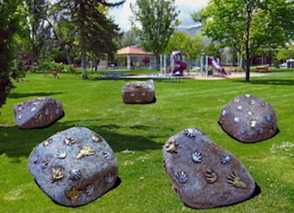 Photo of large rocks with art pieces on them.