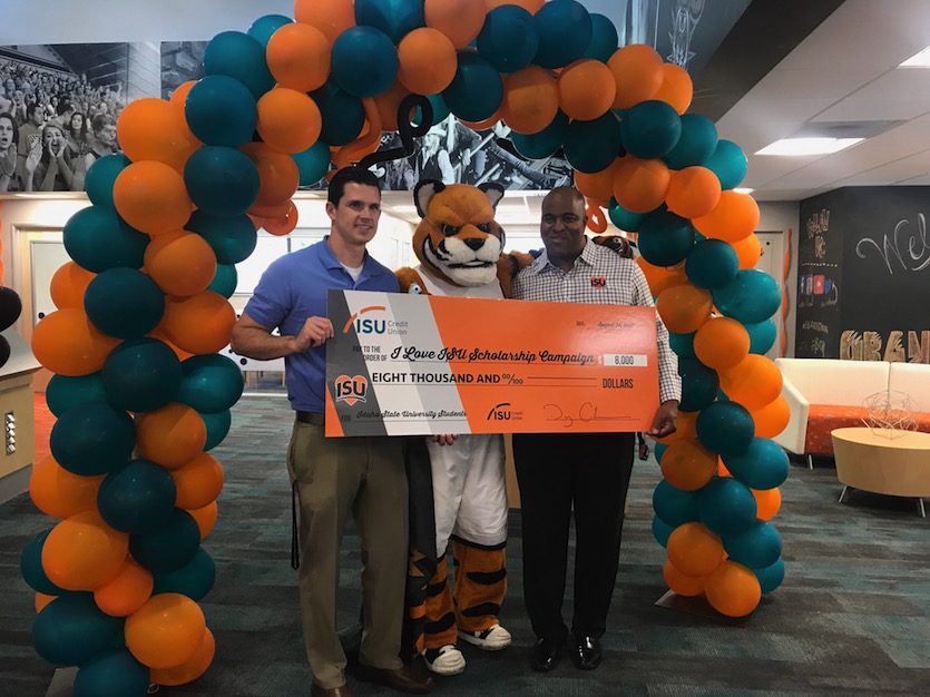 Photo of I Love ISU co-chairs with Benny the Bengal holding big check for $8,000.