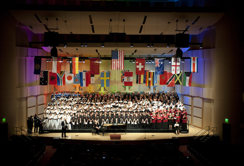 Photo of international choirs on stage at the Jensen Grand Concert Hall.