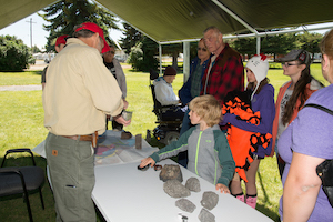 Photo of kids and parents talking to scientist at NASA Arco Community day.