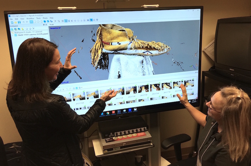 Youngs and Delparte discussing 3-D image creation on a computer screen.