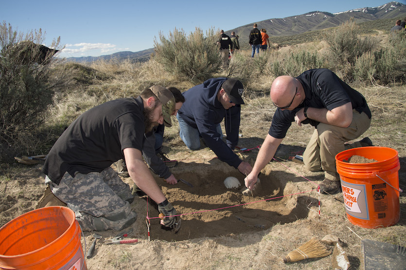 Law enforcement excavating a site