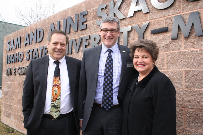 A photo of ISU's Arthur Vailas and Rex Force standing with Susie Balukoff in front of new sign at ISU Meridian
