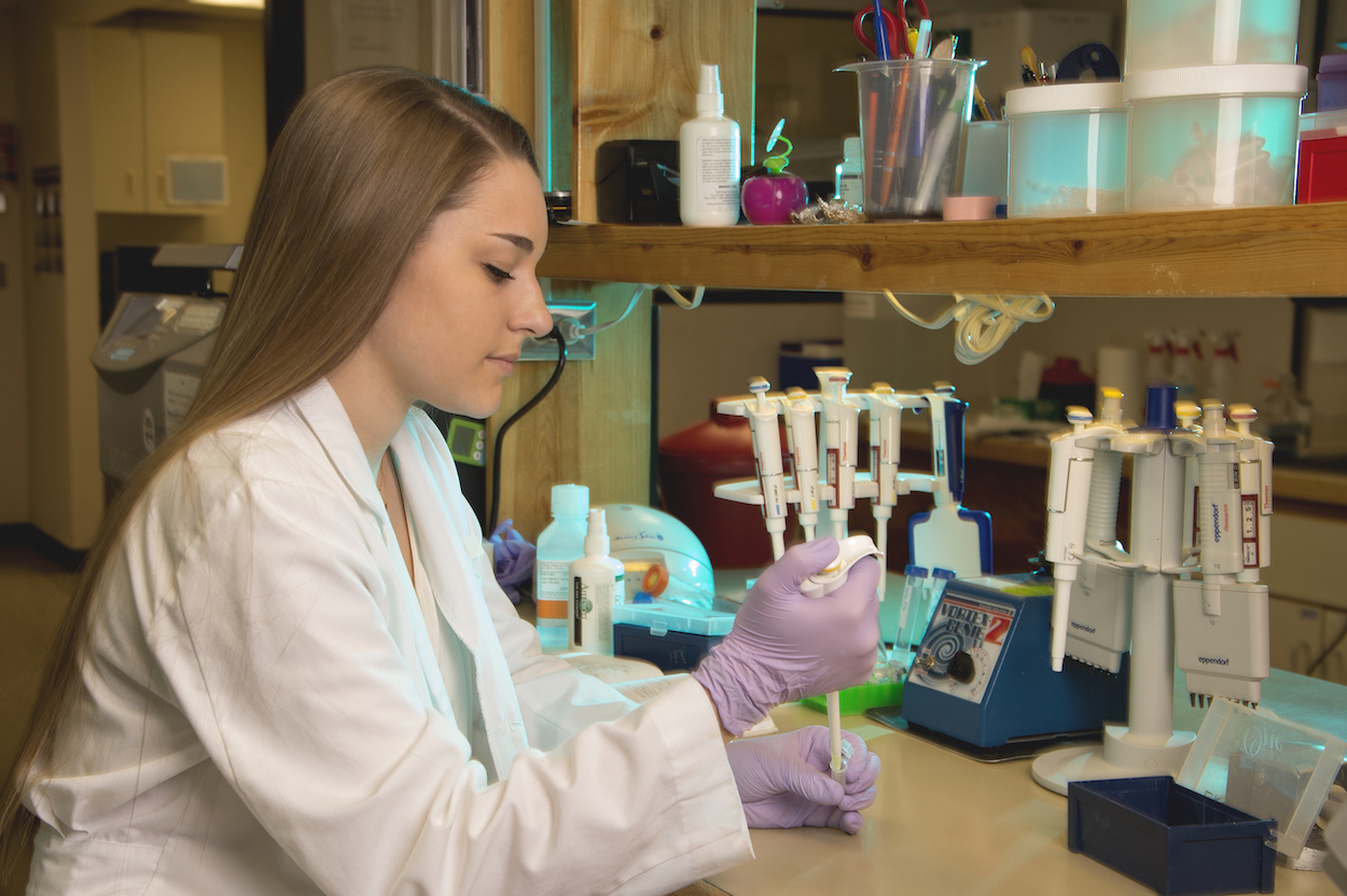 Young woman in lab doing research