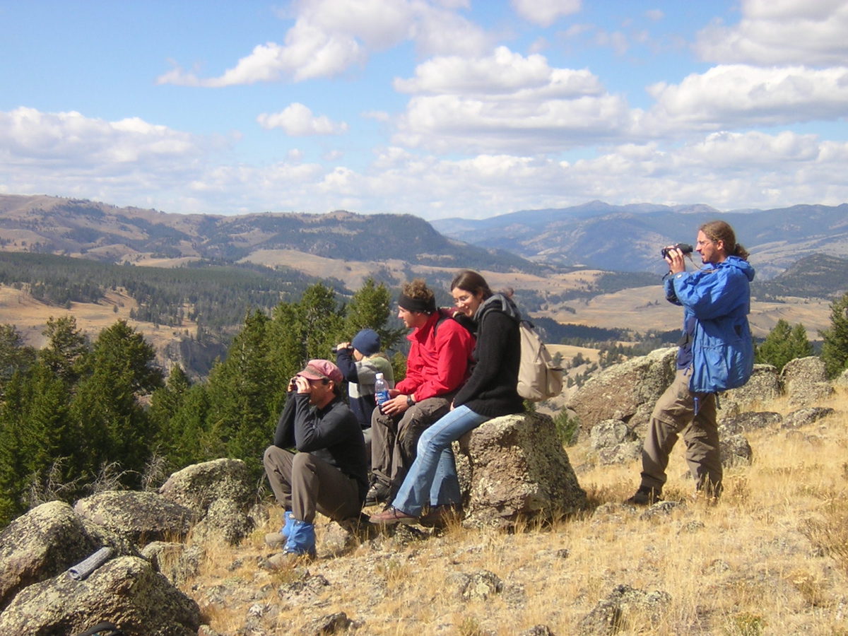 Group on hill scoping with binoculars