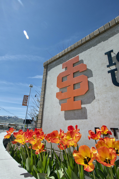 ISU sign with orange flowers in the foreground. 