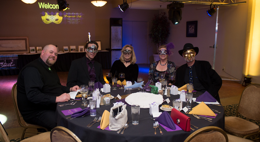 Photo of people in masks at the 2016 masquarade ball.