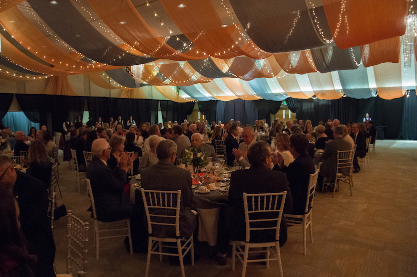 Patrons sitting a tables at 2017 dinner.
