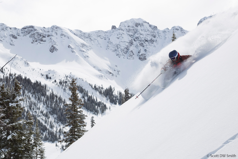 Photo of Pocatello's Ty Peterson skiing through powder snow way up on a mountain ridge.