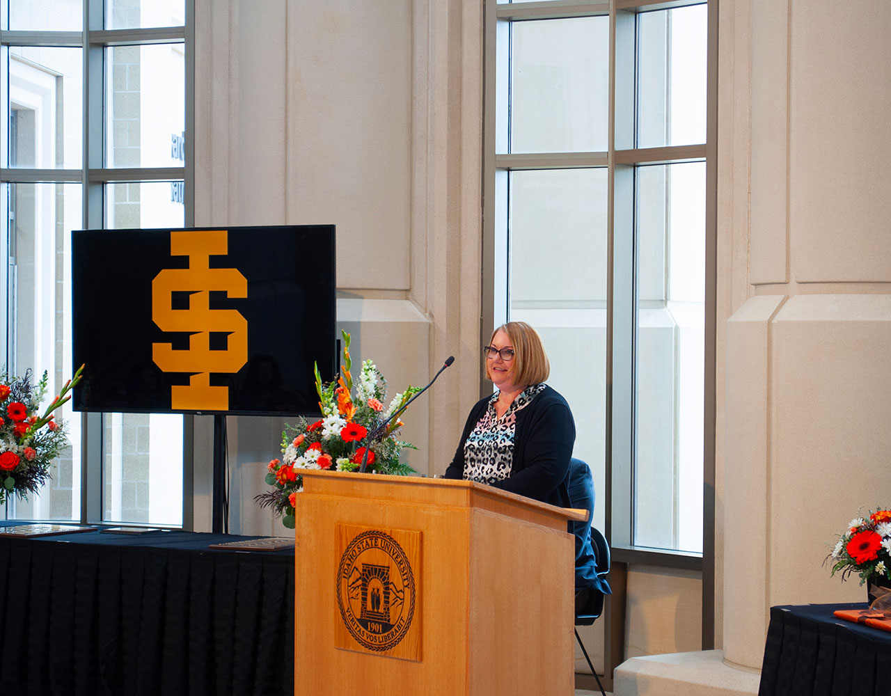 Dr. Amy Blankenship giving a speech behind a podium at ISU