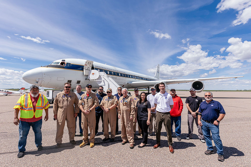 The crew of the NASA Armstrong Flight Research Center standing in front of the plane.