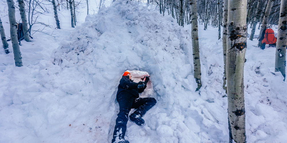 Students learn how to build snow shelters during a class outing in Pocatello’s surrounding mountains.