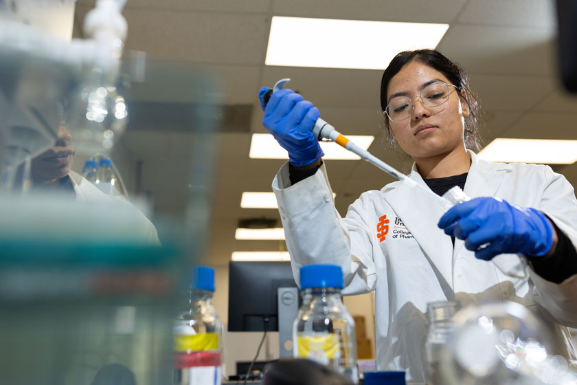 Pharmacy student uses a pipette