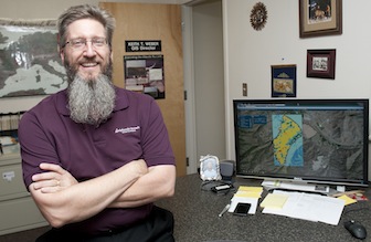 Keith Weber, with new GIS program displayed on the computer in the photo. (ISU Photographic Services by Bethany Baker)