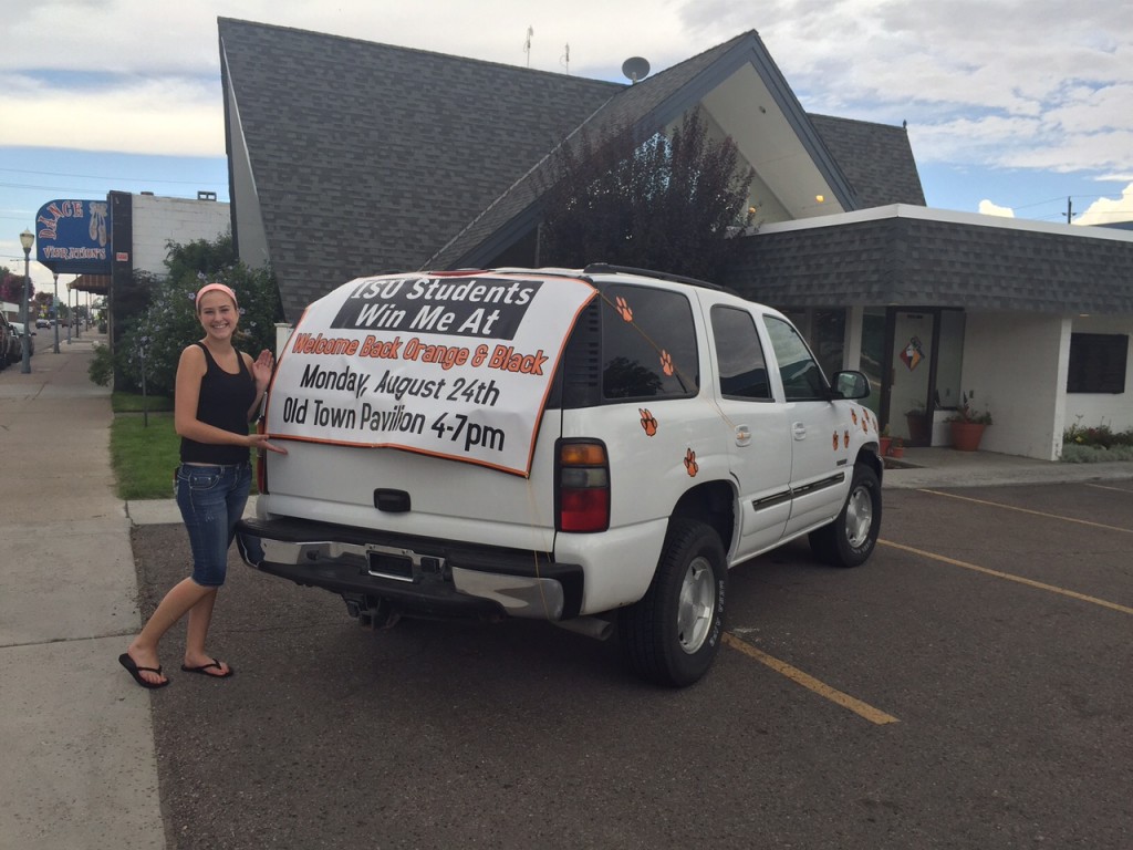 Scarlett Osborn, an ISU Career Path Intern, posing with the Yukon donated by the City of Pocatello that will be given to an ISU student.